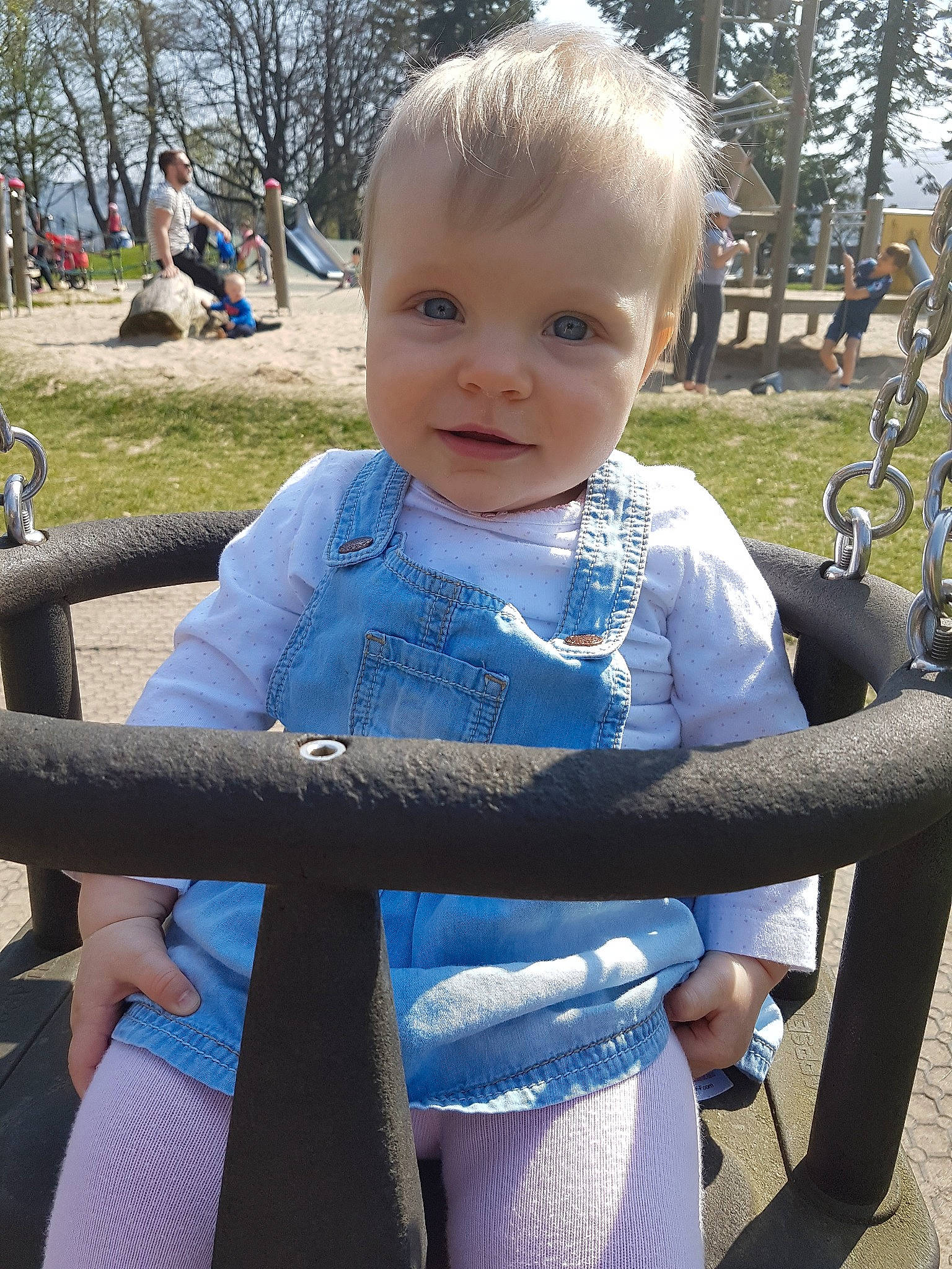 Lilia is registered to the contest to win money with this photo: child, person, playground, public_space, sitting, smile, toddler