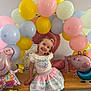 balloons, blue, celebration, child, decoration, dress, festive, girl, happy, headband, indoor, party, pastel_colors, peppa_pig, pink, portrait, smile, table, toy, yellow