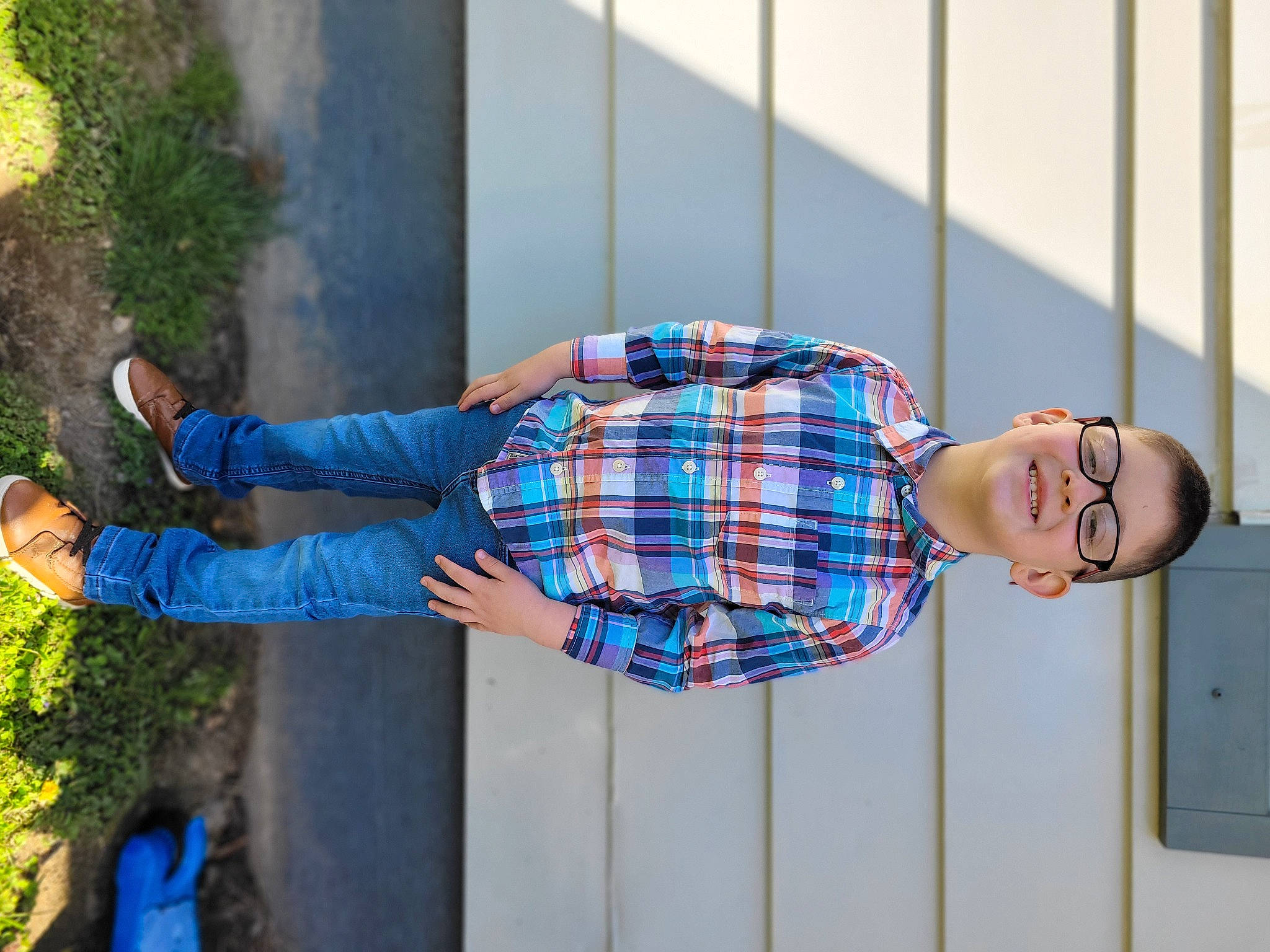Josiah is registered to the contest to win money with this photo: azure, blue, denim, dress, dress_shirt, electric_blue, eyewear, fun, human_leg, joy, leisure, pattern, person, plaid, plant, red, street_fashion, tartan, textile, tree
