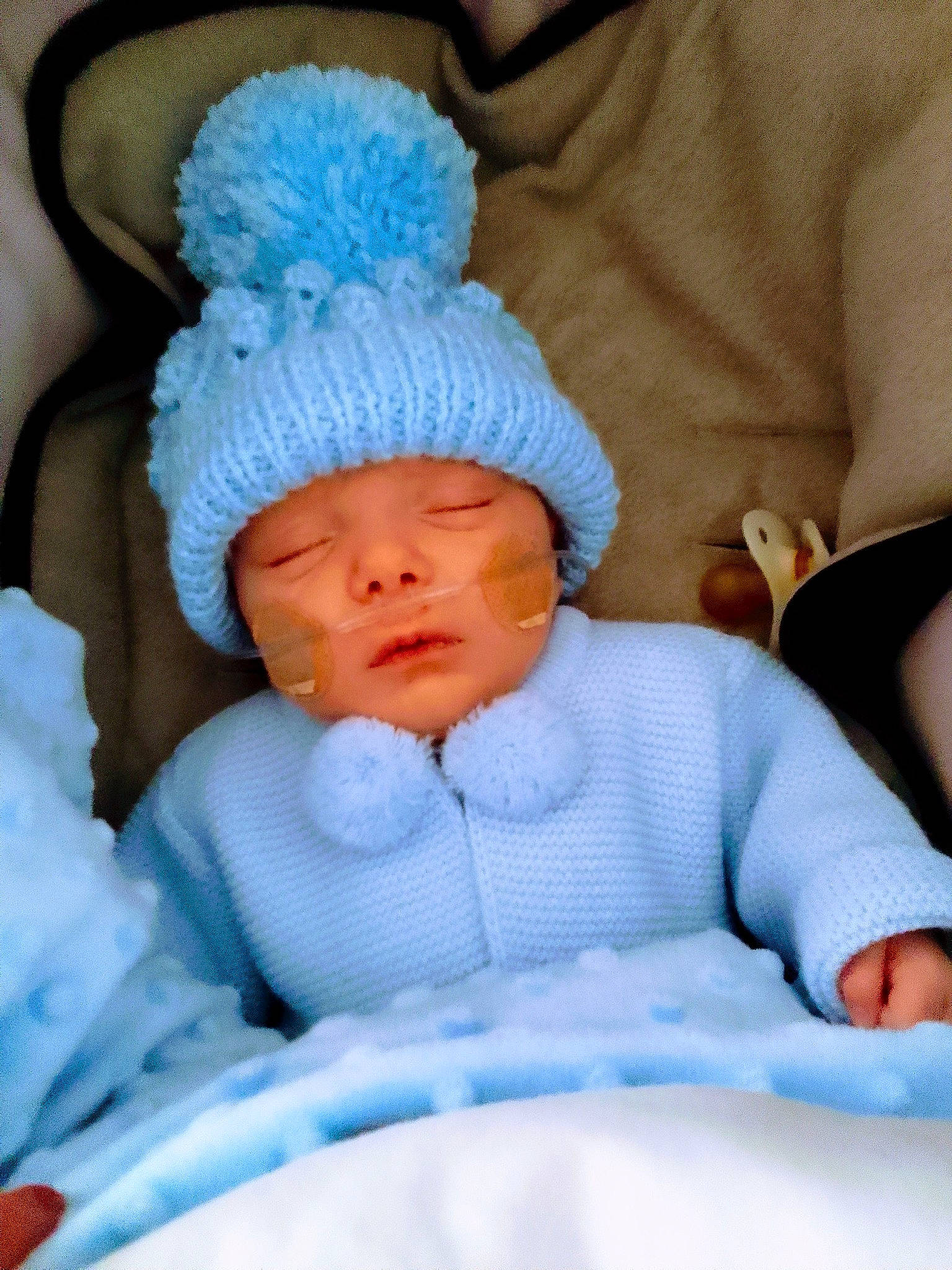 Alfie is registered to the contest to win money with this photo: baby, baby_products, baby_sleeping, baby_toddler_clothing, beanie, bedtime, blue, cap, cheek, child, comfort, headwear, knit_cap, linens, mouth, nap, person, room, skin, sleep