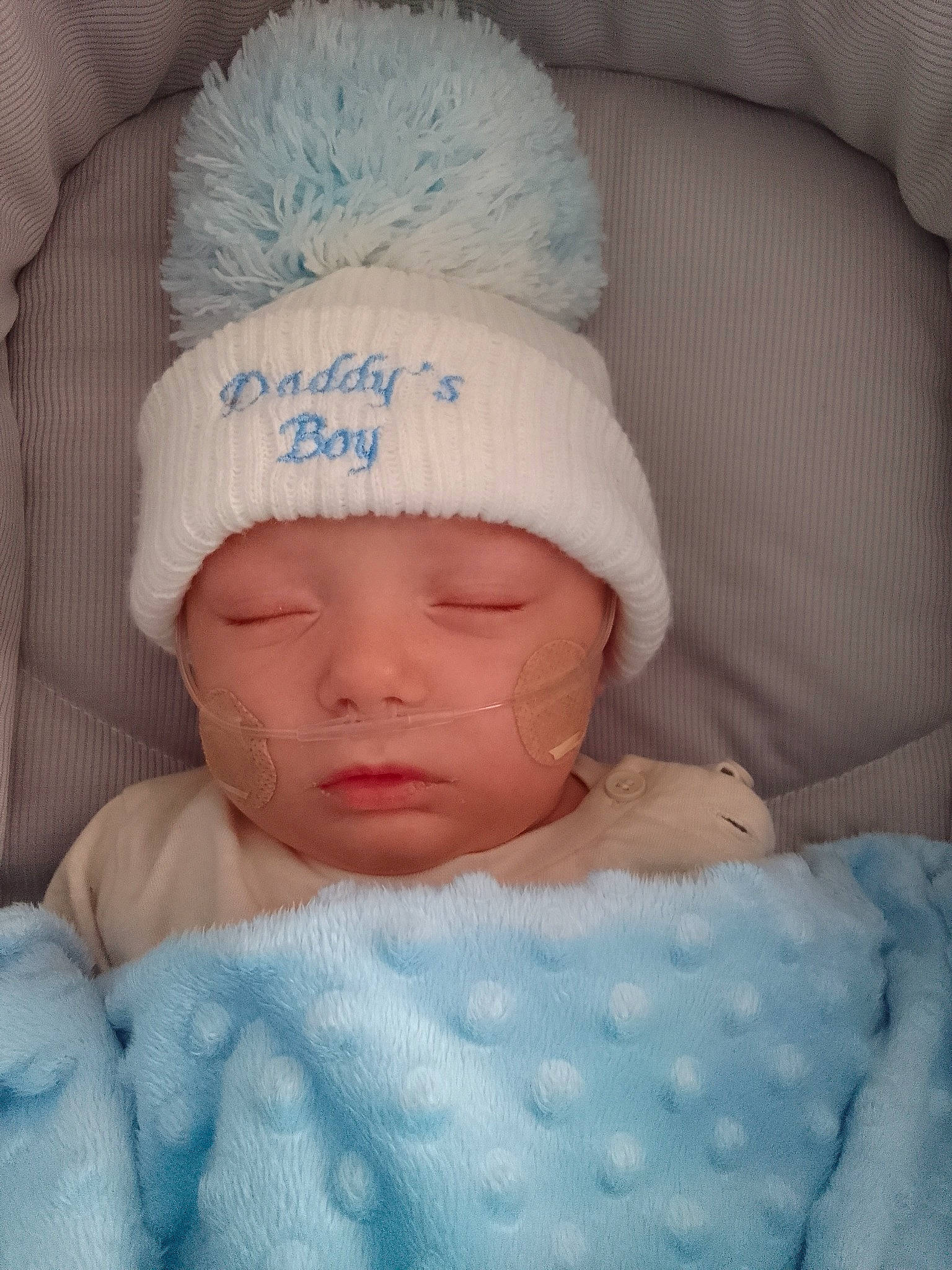 Alfie is registered to the contest to win money with this photo: baby, baby_products, baby_sleeping, baby_toddler_clothing, cap, cheek, child, chin, comfort, eye, face, facial_expression, finger, head, headgear, headwear, linens, person, skin, textile