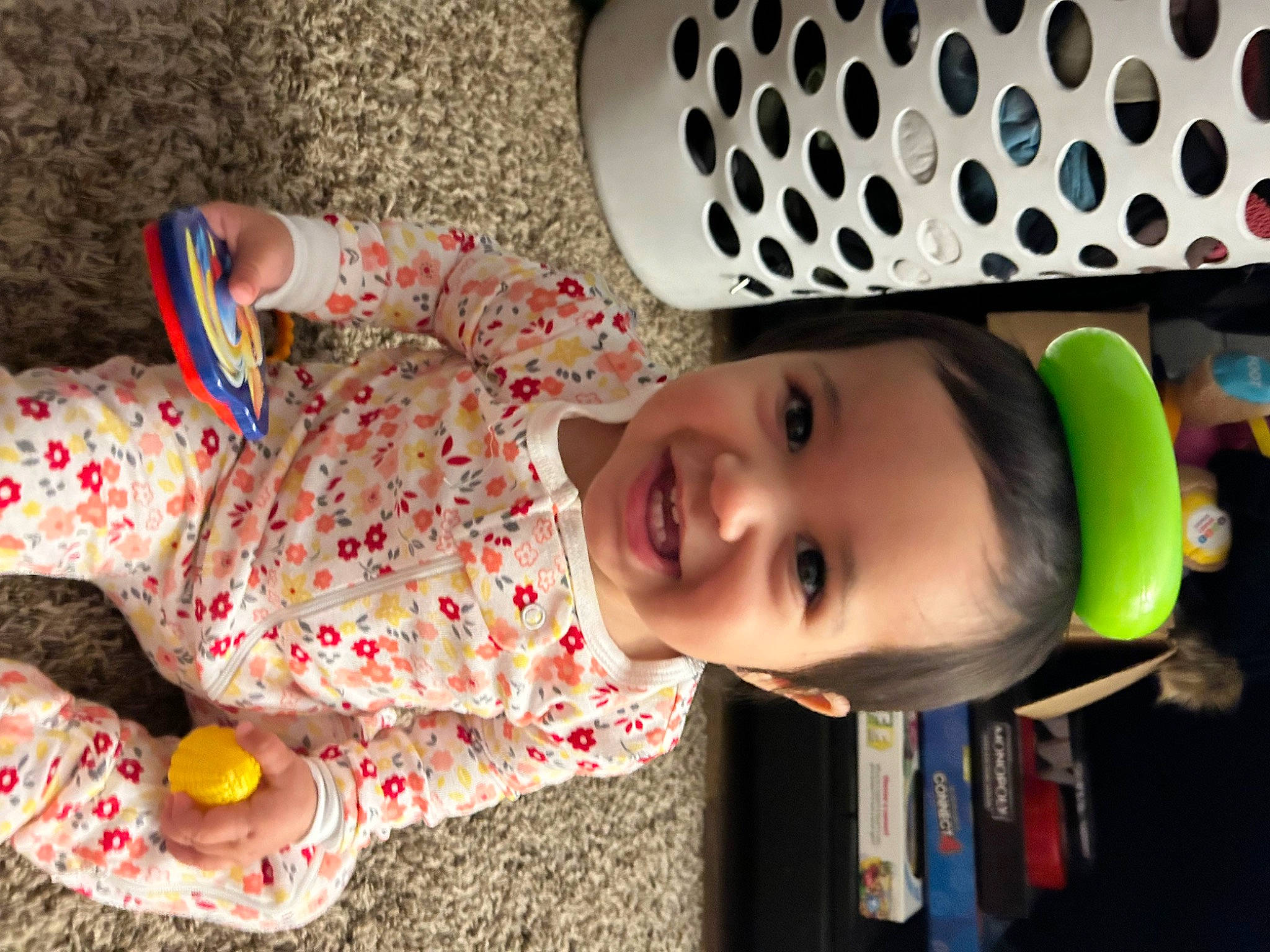 Rain is registered to the contest to win money with this photo: baby, baby_toddler_clothing, child, design, eye, eyewear, facial_expression, flooring, fun, hair, happy, joy, nose, pattern, person, personal_protective_equipment, play, product, room, smile