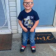 Chase joined the competition — help win amazing prizes! child, boy, glasses, smiling, standing, blue_door, transformers_shirt, jeans, sneakers, chalk_drawing, sidewalk, door_mat, hair_tied_up, outdoor, happy, concrete, front_door, casual_clothing, portrait, daylight