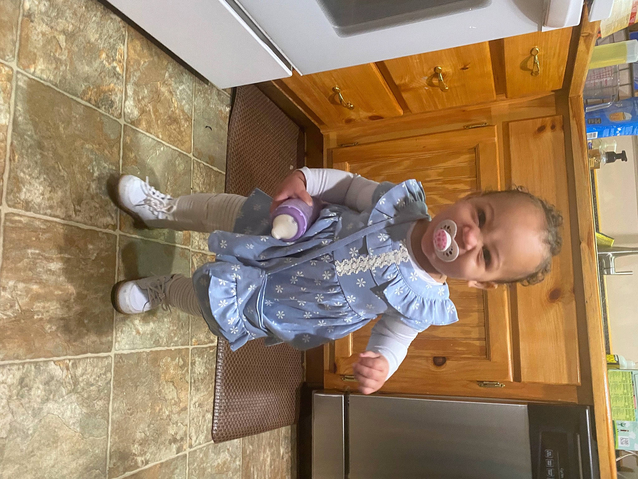 Leighton is registered to the contest to win money with this photo: baby_toddler_clothing, ceiling, child, comfort, concrete, flooring, fun, hardwood, hat, leisure, outdoor_shoe, person, play, room, sitting, sneakers, t_shirt, thigh, toddler, walking_shoe