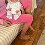 Lovella is registered to the contest to win money with this photo: baby, sleeping, bow, headband, pink_clothing, person, couch, blanket, wood_floor, home_interior, relaxing, infant, soft_lighting, white_outfit, legs, hand, toe_nail_polish, cozy, indoor, resting