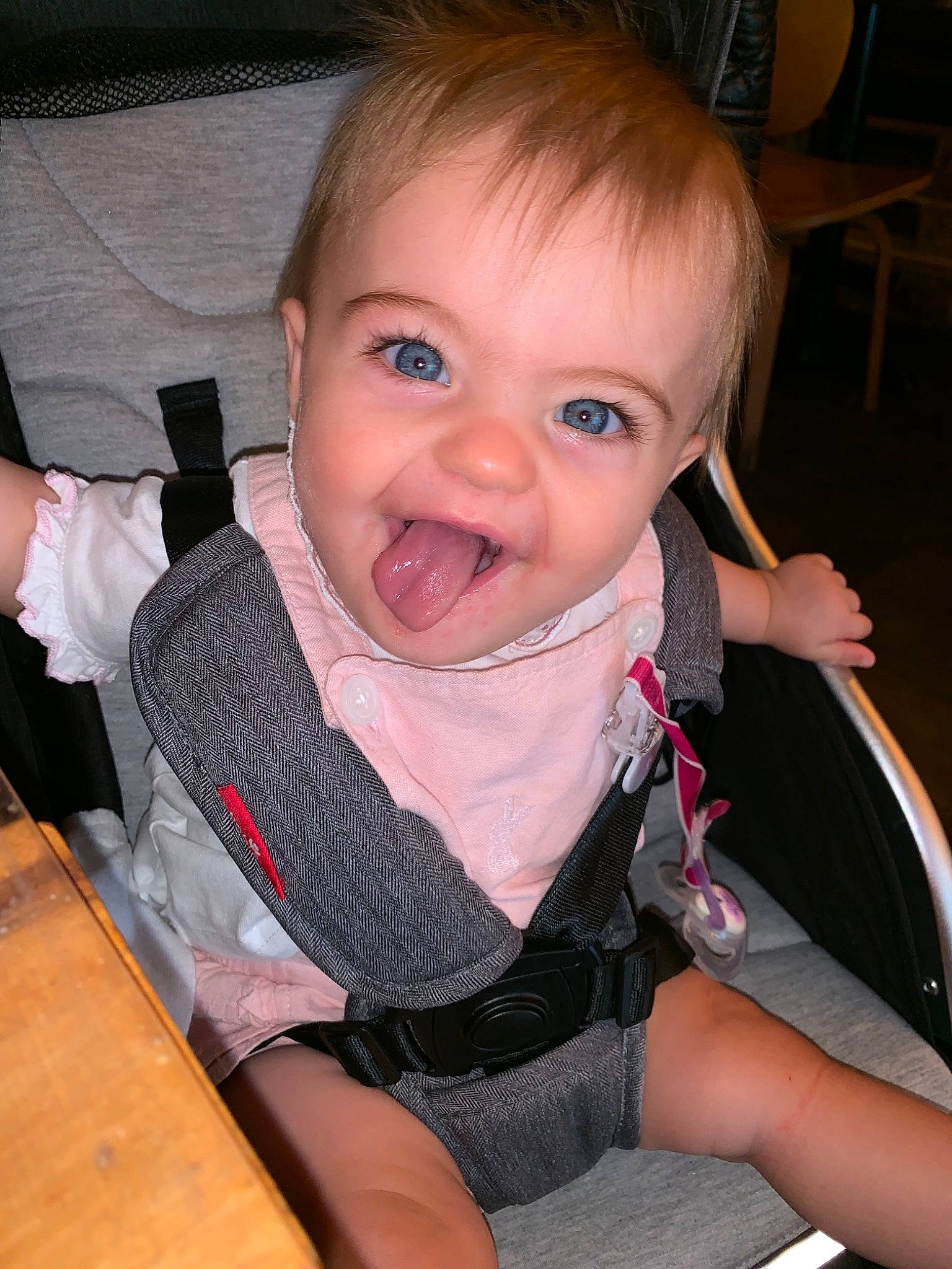 Macey is registered to the contest to win money with this photo: baby, car_seat, cheek, child, chin, eye, face, facial_expression, finger, hand, head, mouth, neck, nose, person, sitting, skin, smile, toddler, tongue