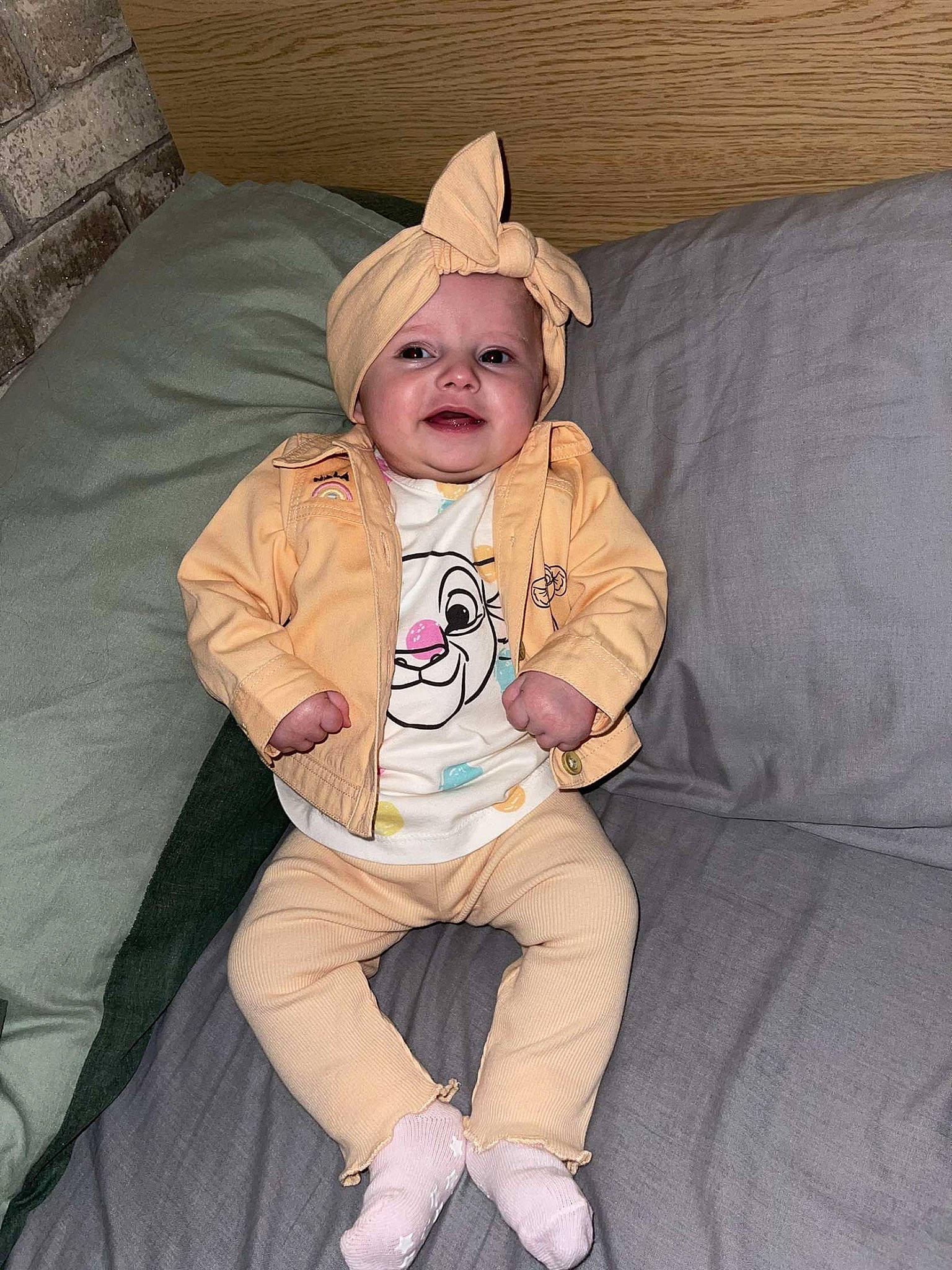 Emilia joined the competition — help win amazing prizes! baby, baby_toddler_clothing, cheek, child, comfort, couch, eye, face, fun, happy, head, headwear, human_body, lap, linens, person, sitting, skin, sleeve, textile