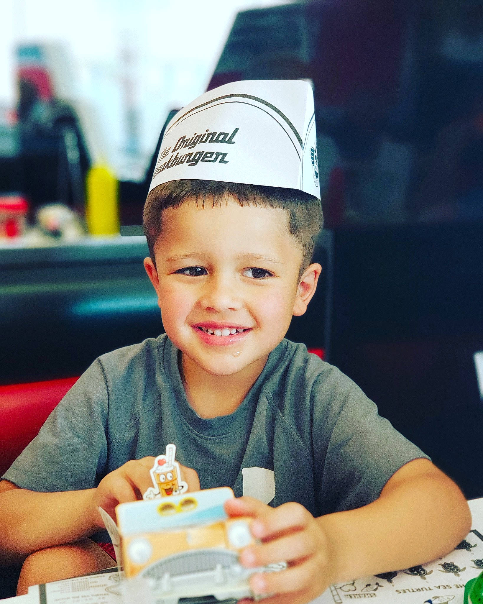 Trèvon is registered to the contest to win money with this photo: baby, birthday, cake, cap, child, dairy, dessert, eating, food, happy, head, headgear, joy, male, party, person, restaurant, smile, snapshot, toddler