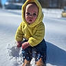 baby, child, snow, yellow_hoodie, hood, costume, boots, blue_jeans, outdoor, winter, cold, cute, portrait, sitting, face, eyes, curious, nature, daylight, funny
