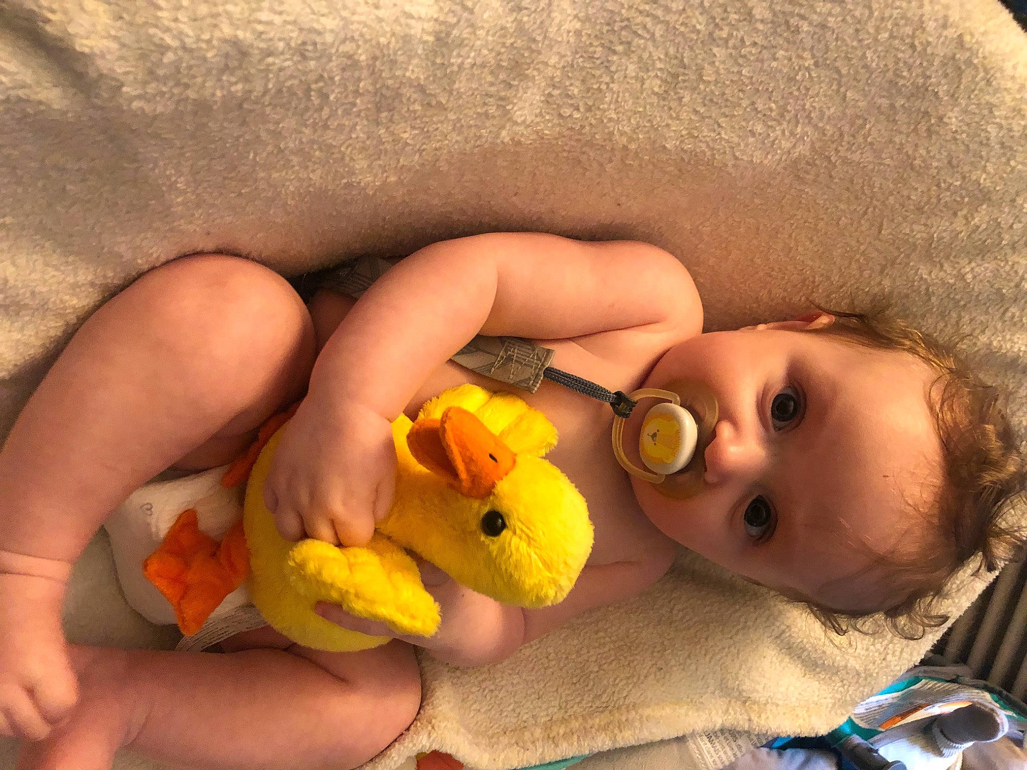 Asher is registered to the contest to win money with this photo: baby, cheek, comfort, eyelash, finger, gesture, happy, human_body, iris, lip, mouth, nail, neck, nose, person, skin, textile, thumb, toddler, toy