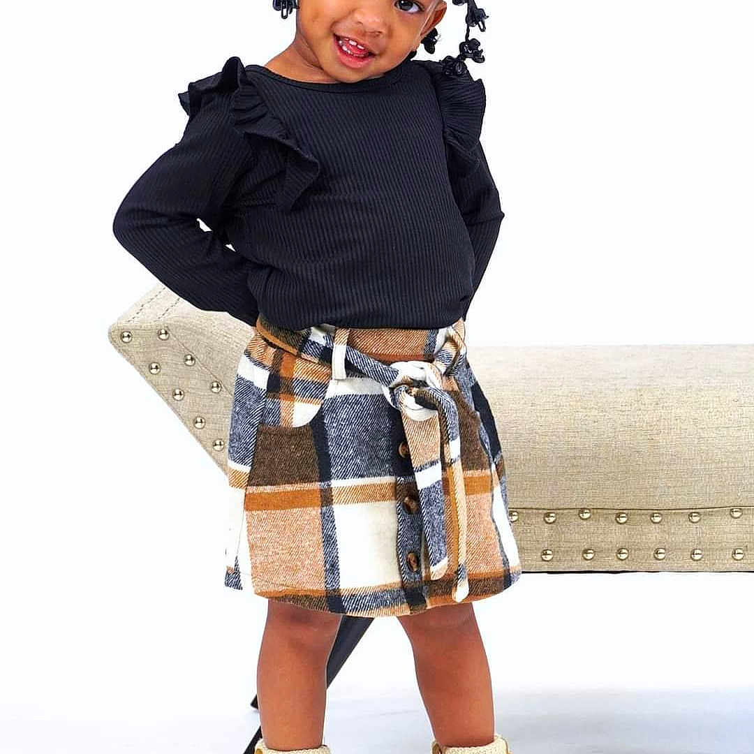 Aliyah is registered to the contest to win money with this photo: cape, child, clothing, face, female, footwear, girl, head, highheel, kilt, miniskirt, person, photography, portrait, shoe, shorts, skirt, sleeve, standing, tartan