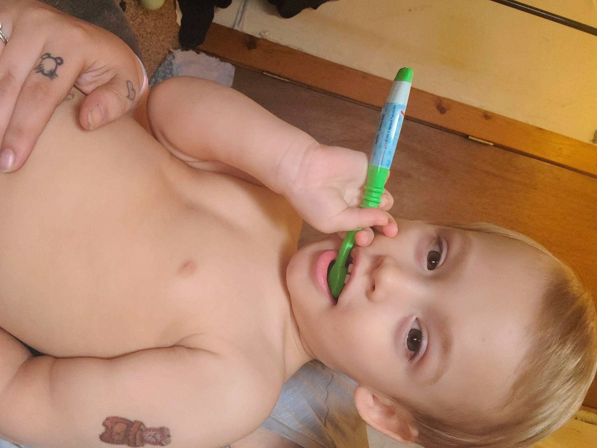 Gionni is registered to the contest to win money with this photo: baby, bathing, cheek, chest, child, ear, eyebrow, eyelash, face, finger, hand, human_body, mouth, muscle, nose, person, skin, thumb, toddler, tooth_brushing