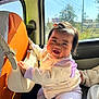 Yulin Fung Tumbapo joined the competition — help win amazing prizes! baby, smiling, car_interior, handbag, orange_seat_cover, window, sunlight, clothing, child, person, face, happy, sitting, cute, infant, jacket, pants, hair, daylight, seatbelt