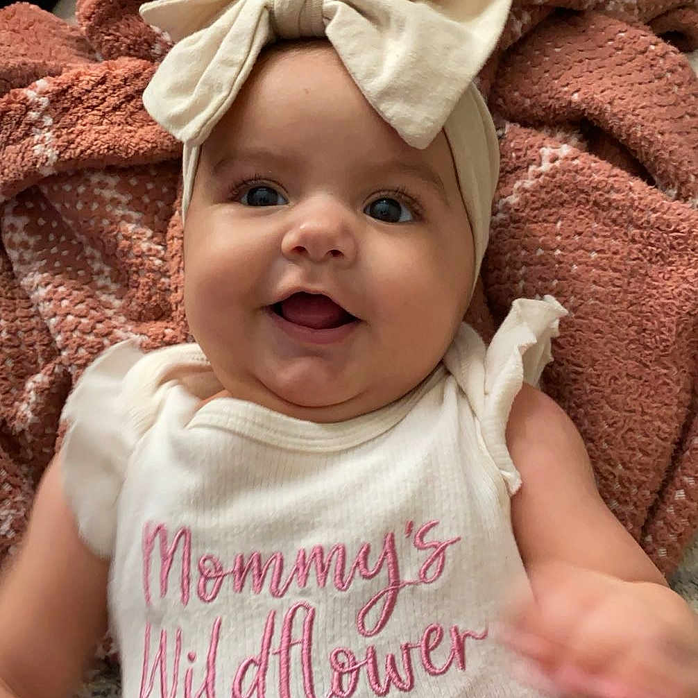 Orianna is registered to the contest to win money with this photo: accessories, baby, babylaughing, blanket, cap, clothing, cushion, face, happy, hat, head, homedecor, laughing, newborn, person, photography, portrait, quilt, smile, t_shirt