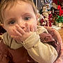 baby, child, hand, face, eyes, clothing, pink, seat, furniture, christmas, decoration, holiday, santa, indoor, cute, person, infant, closeup, festive, background