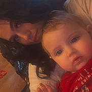 Willow joined the competition — help win amazing prizes! baby, woman, indoor, portrait, face, child, person, holiday, red_clothing, long_hair, black_hair, light, window, expression, closeup, cute, adult, infant, family, cozy