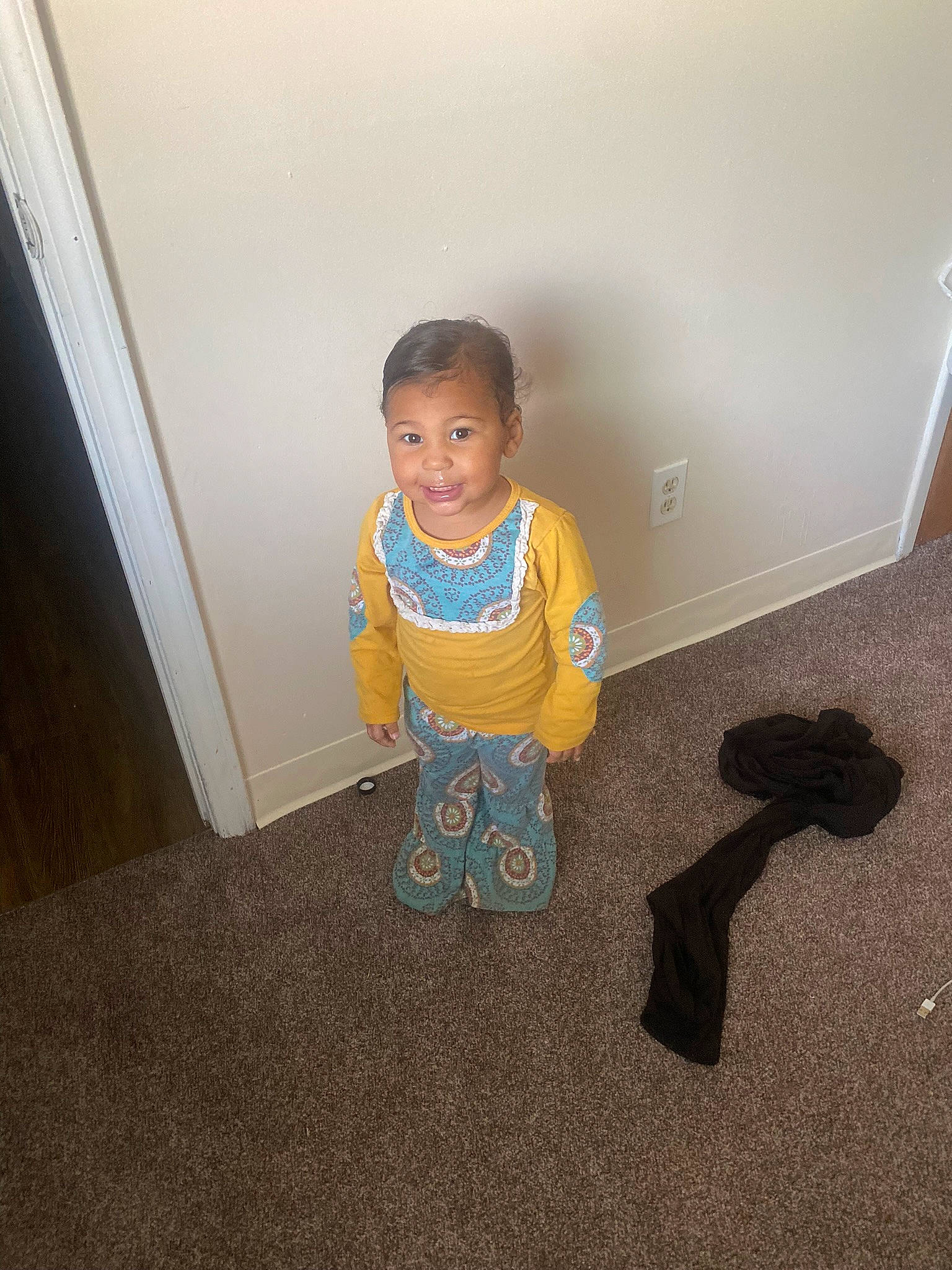 Aryana is registered to the contest to win money with this photo: baby, baby_toddler_clothing, child, floor, flooring, fun, hardwood, human_body, joy, pattern, person, play, room, sitting, sleeve, smile, standing, t_shirt, toddler, wood