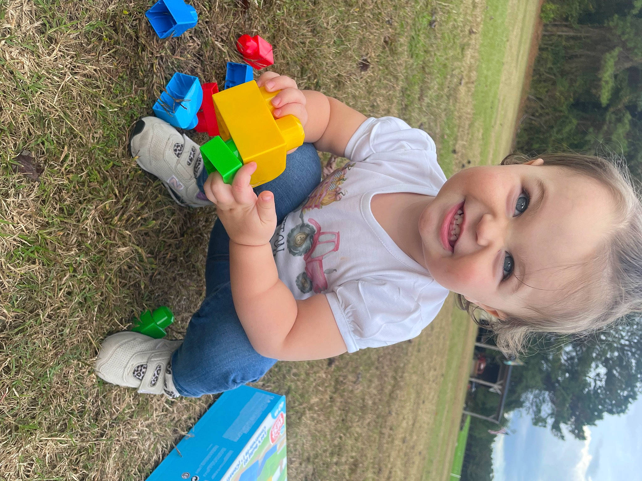 Sutton joined the competition — help win amazing prizes! blue, child, fun, grass, green, happy, leisure, people_in_nature, person, plant, plastic, play, recreation, sitting, sky, smile, toddler, toy, tree, vacation