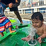 toddler, child, water, splash, pool, outdoor, summer, play, happy, person, green, shorts, swimwear, fence, sunlight, adult, hand_holding, wet_hair, foot, smile