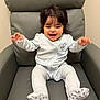 Vanellope is registered to the contest to win money with this photo: baby, child, smiling, happy, pajamas, sitting, chair, indoor, cute, infant, young_child, person, clothing, footwear, head, face, expression, comfort, playful, cozy