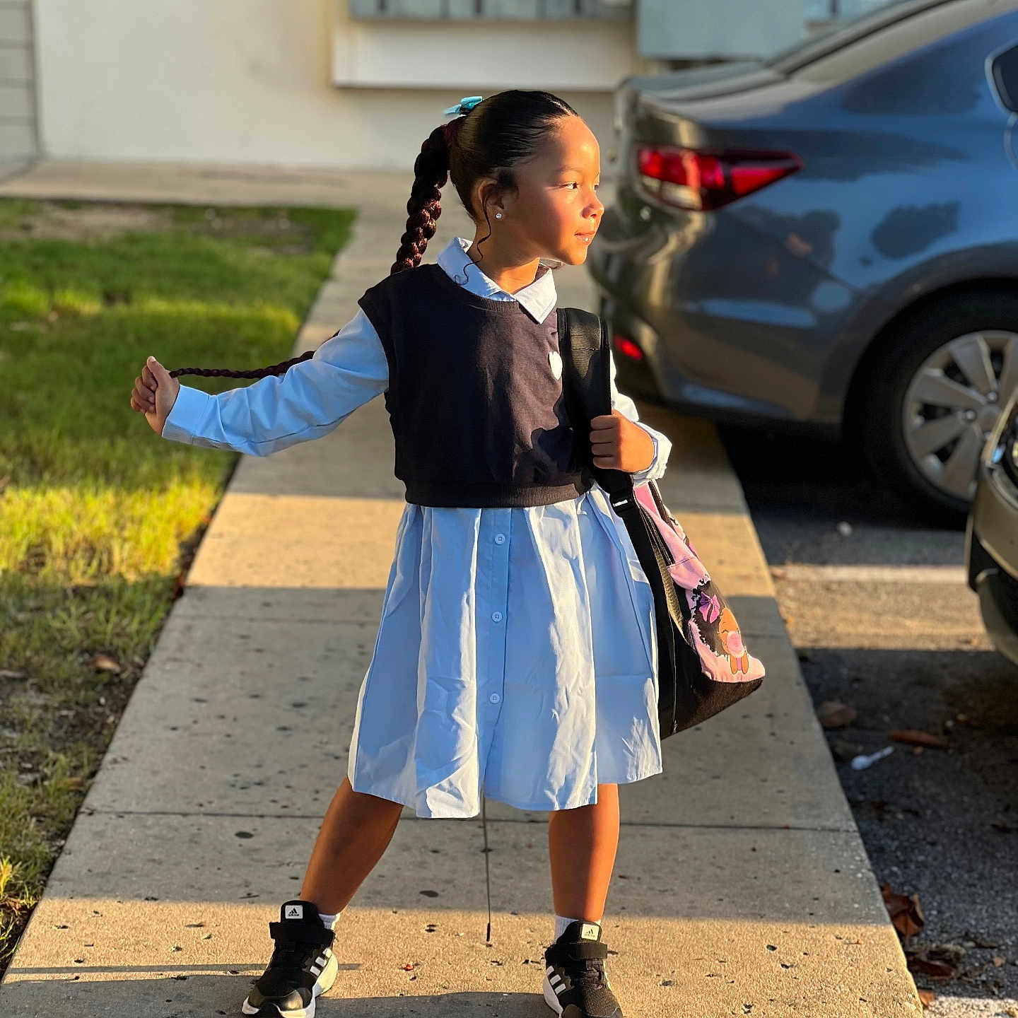 Maria Valentina is registered to the contest to win money with this photo: accessories, bag, car, child, clothing, face, female, footwear, girl, handbag, machine, pedestrian, person, shoe, sitting, skirt, transportation, vehicle, walking, wheel