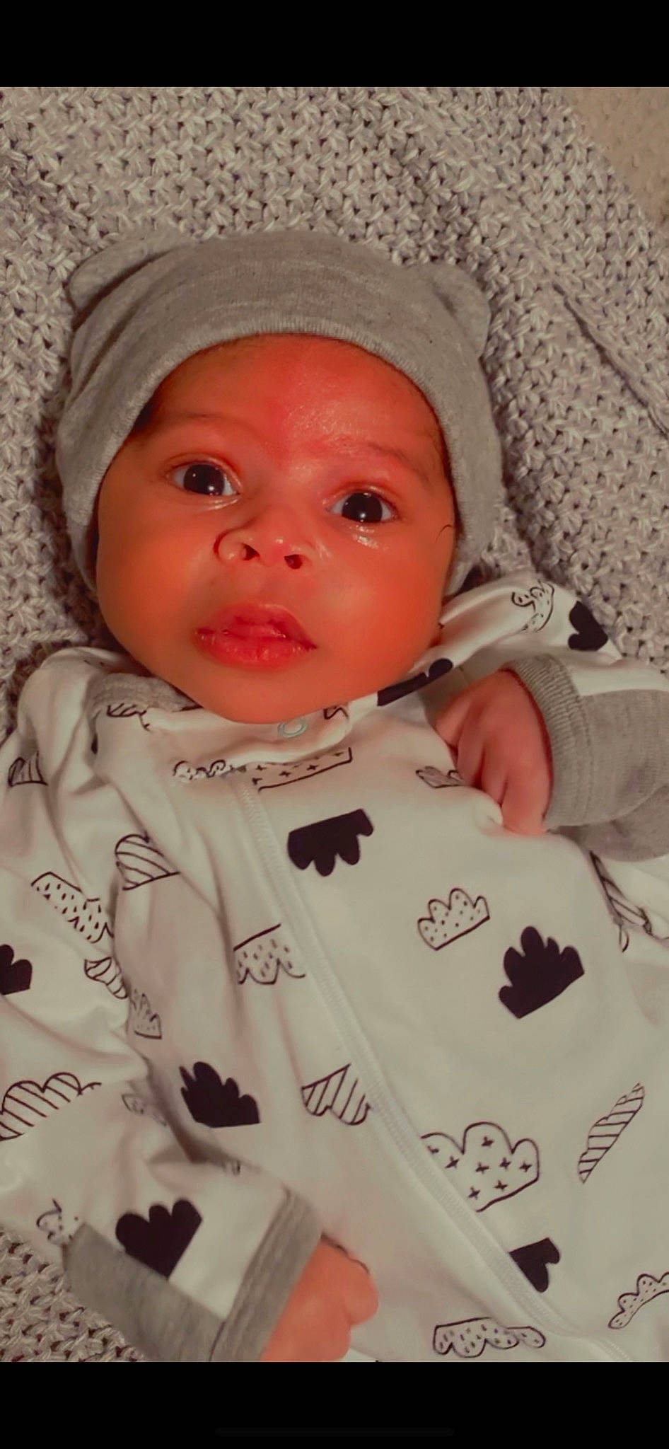 Jericho is registered to the contest to win money with this photo: baby, baby_products, baby_toddler_clothing, cheek, child, collar, comfort, eye, eyelash, headwear, human_body, lip, nose, outerwear, pattern, person, pink, skin, sleeve, t_shirt