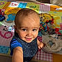 toddler, child, smiling, face, arm, toys, playmat, indoors, sunlight, scratches, baby, clothing, floor, pacifier, colorful, playtime, person, happy, cute, home