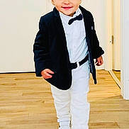 Elan participe au concours pour gagner de l'argent avec cette photo : black_blazer, bow_tie, boy, casual, child, cute, fashion, floor, happy, home, indoor, person, portrait, smiling, sneakers, toddler, walking, white_pants, white_shirt, wooden_floor