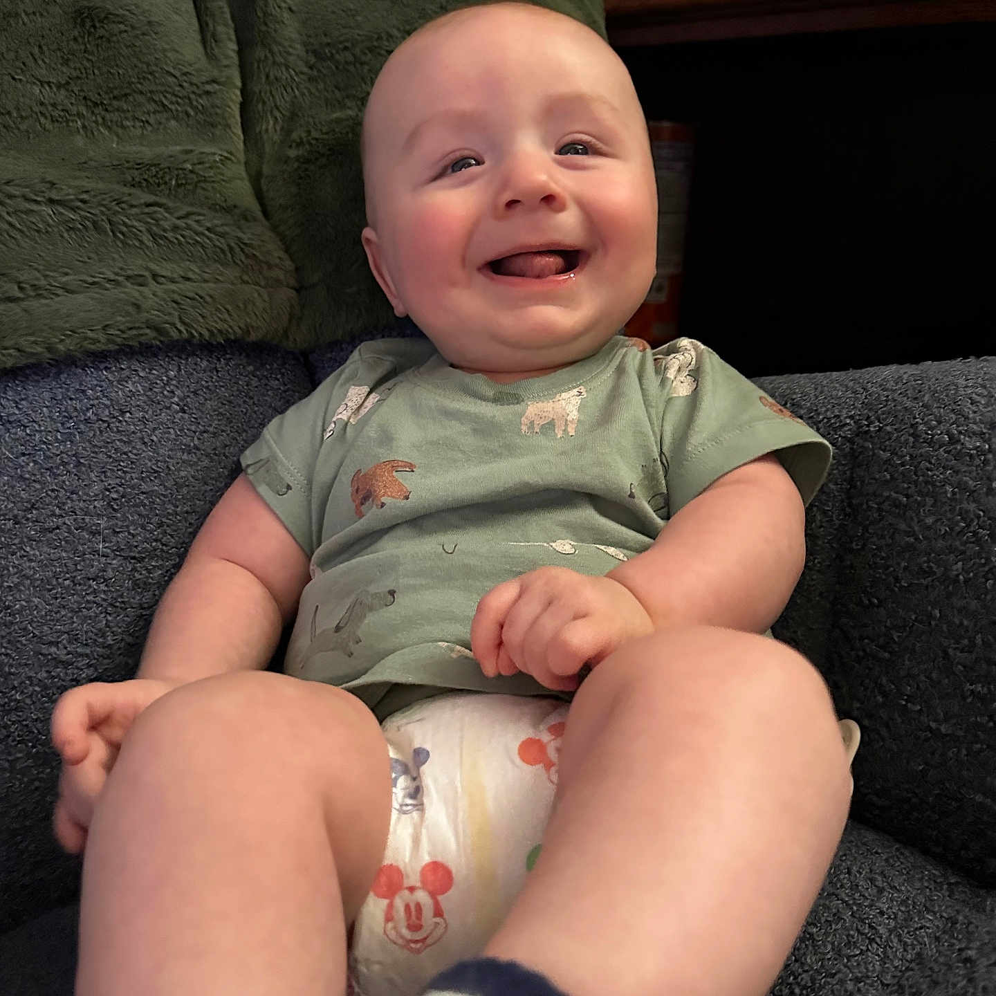 Theo is registered to the contest to win money with this photo: baby, babylaughing, clothing, couch, cushion, face, furniture, happy, head, homedecor, laughing, pants, person, photography, portrait, shorts, sitting, smile, t_shirt