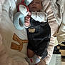 baby, sleeping, plush_toy, blanket, denim_overalls, socks, cozy, cute, indoor, soft, comfort, child, resting, peaceful, warm, cuddle, heart_doodle, fabric, furniture, infant