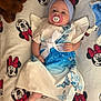 Célina-Marie a rejoint le concours — aidez-le/la à gagner de superbes lots ! baby, pacifier, headband, dress, butterfly, blanket, minnie_mouse, plush_toy, foot, hand, face, infant, lying_down, cute, soft, blue, white, pattern, child, indoors