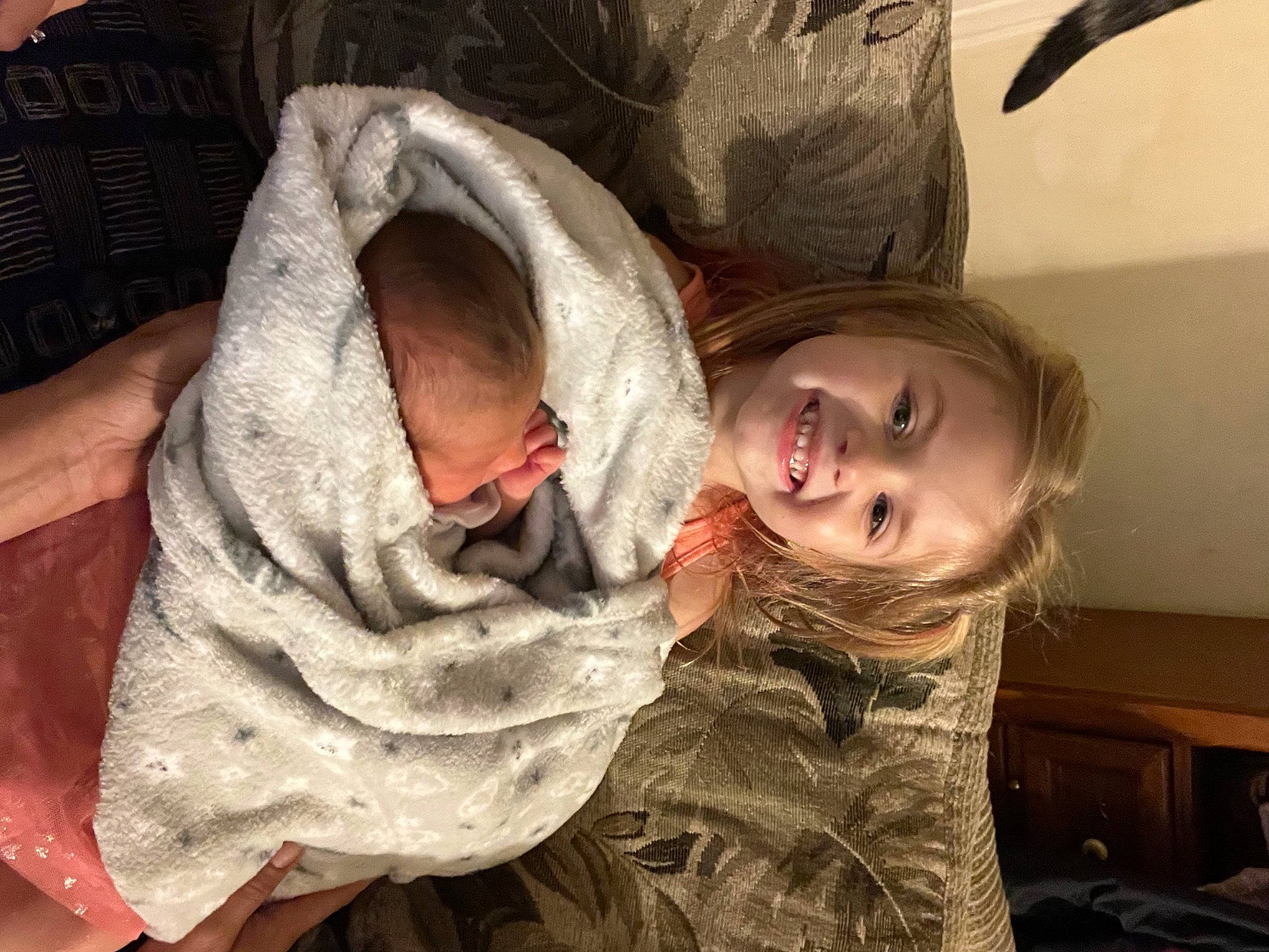 Raelynn is registered to the contest to win money with this photo: cheek, child, comfort, event, eye, face, fun, fur, gesture, happy, head, joy, mouth, nose, person, room, sitting, skin, smile, toddler