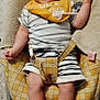 Hélios participe au concours pour gagner de l'argent avec cette photo : arms, baby, baby_seat, bib, carpet, child, closeup, fabric, face, footwear, happy, indoor, infant, legs, pacifier_clip, person, plaid_pattern, smiling, striped_clothing, towel