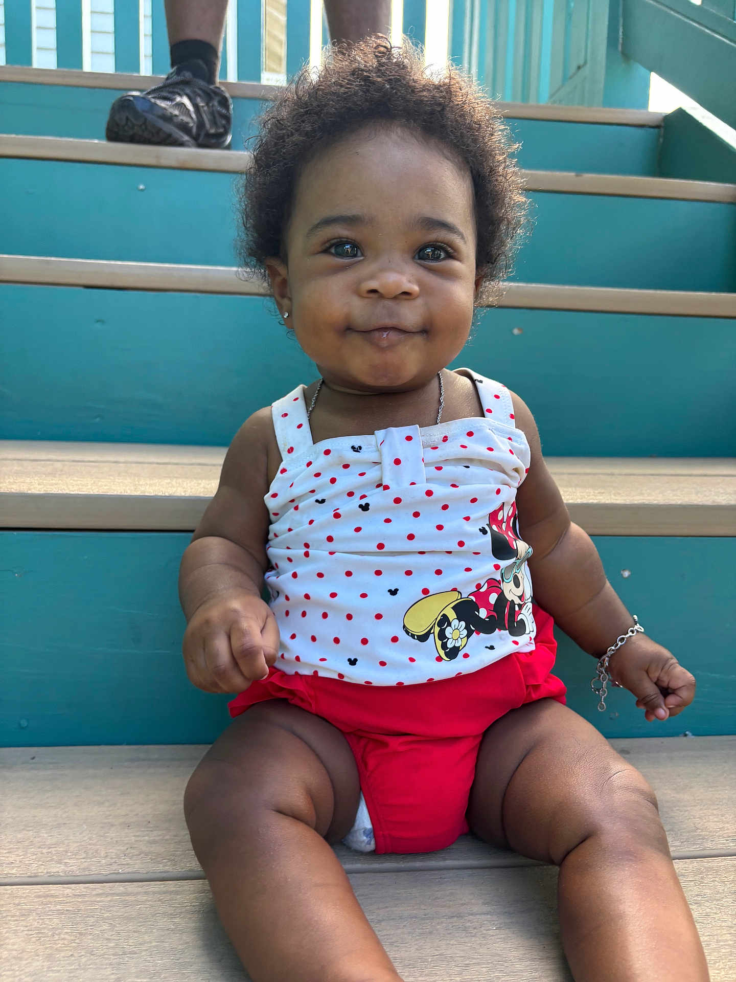 Oaklynn joined the competition — help win amazing prizes! baby, child, stairs, sitting, smiling, polka_dot, red_shorts, white_top, minnie_mouse, bracelet, necklace, curly_hair, outdoor, sunlight, happy, cute, person, portrait, skin, footwear