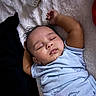 baby, sleeping, infant, onesie, blue_clothing, arms_up, closed_eyes, peaceful, soft_blanket, bottle, cute, indoor, portrait, child, resting, young, toddler, sleep, comfort, adorable