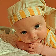 Michael joined the competition — help win amazing prizes! baby, infant, face, blue_eyes, hat, striped_clothing, closeup, portrait, hand, curious, resting, soft_lighting, indoors, child, skin, cute, expression, headwear, young, person