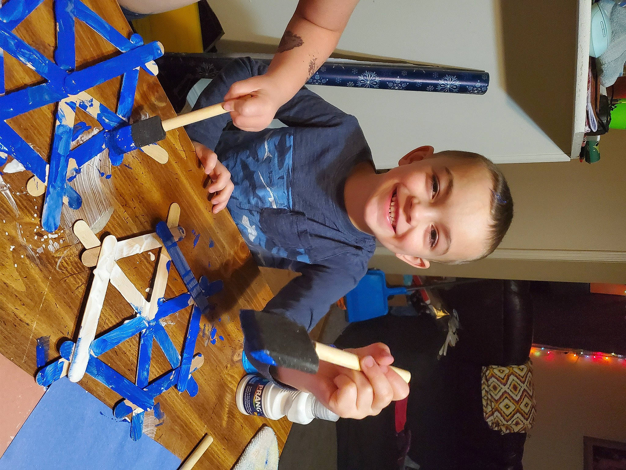 Sawyer is registered to the contest to win money with this photo: art, chair, child, electric_blue, engineering, flooring, folding_chair, fun, happy, joy, leisure, machine, person, play, smile, t_shirt, table, toddler, triangle, visual_arts