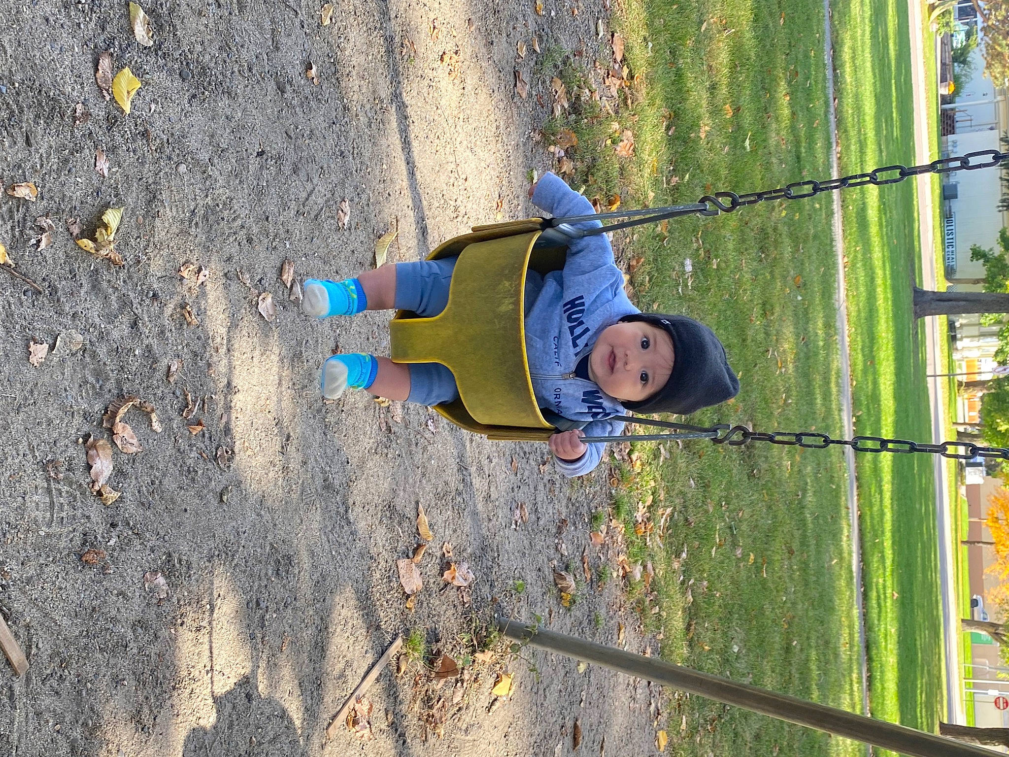 Sebastian is registered to the contest to win money with this photo: asphalt, child, city, concrete, electric_blue, fence, fun, grass, headwear, landscape, leisure, people_in_nature, person, plant, recreation, rope, shadow, sky, toddler, tree