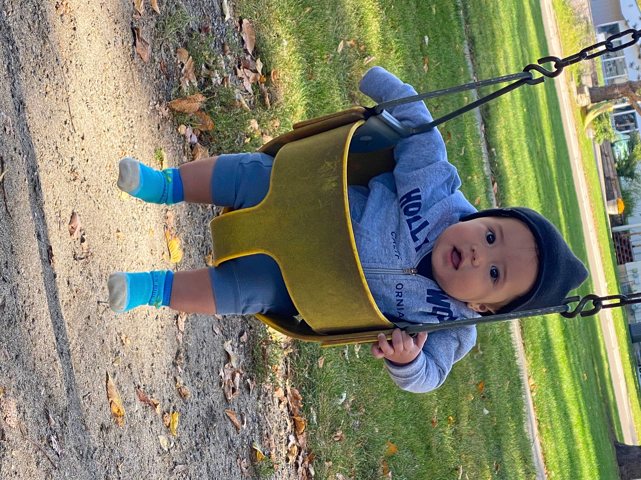 Sebastian is registered to the contest to win money with this photo: city, denim, electric_blue, fun, grass, happy, hat, headwear, human_leg, leaf, leisure, people_in_nature, person, plant, recreation, smile, snapshot, sneakers, toddler, tree