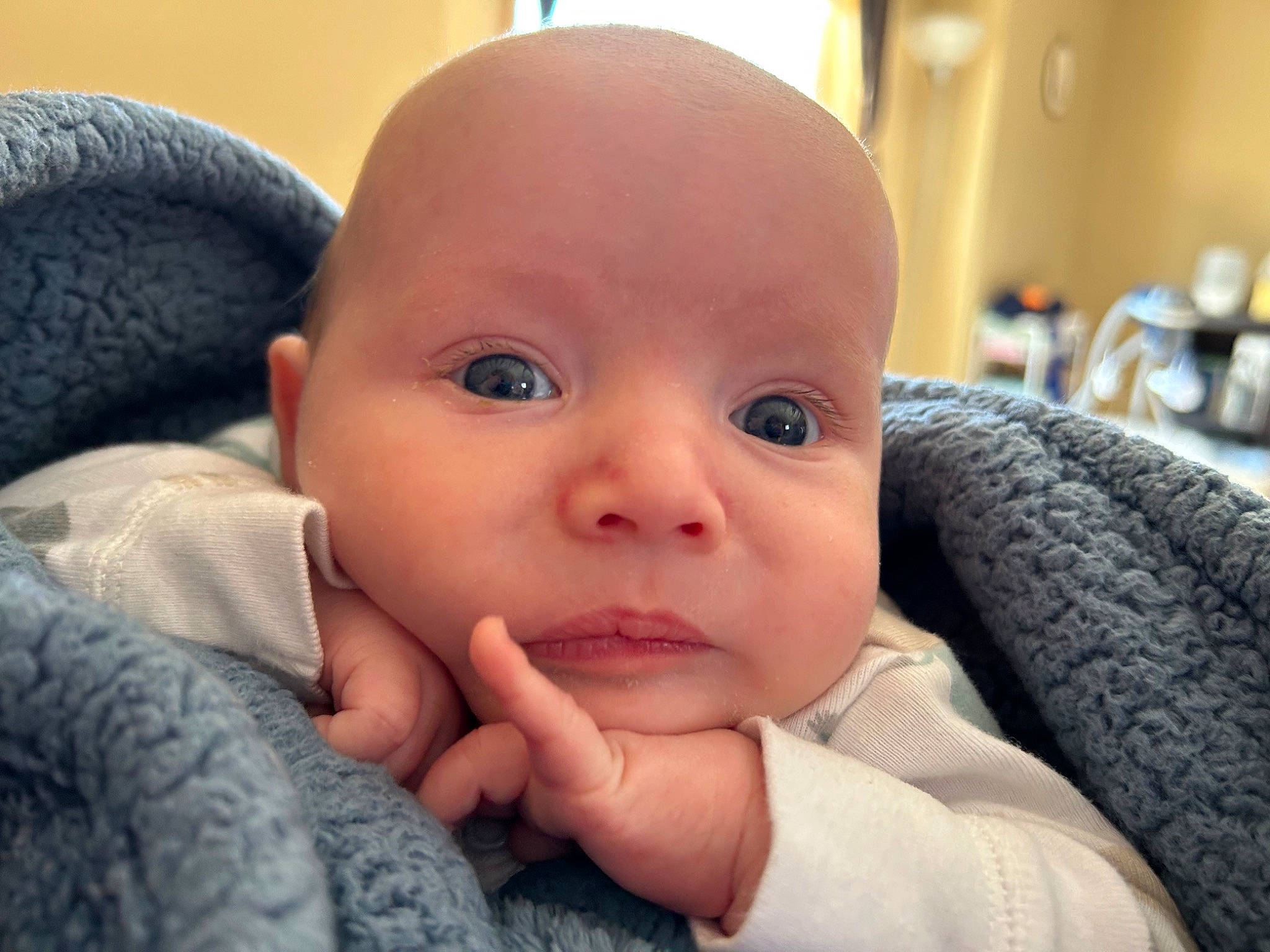 Evan is registered to the contest to win money with this photo: baby, baby_toddler_clothing, cheek, child, comfort, ear, eyelash, finger, gesture, hand, happy, human_body, iris, nail, nose, person, sitting, skin, thumb, toddler