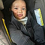 Keadon joined the competition — help win amazing prizes! baby, child, face, smile, hoodie, black_clothing, car_seat, warning_label, fabric, infant, cute, portrait, zipper, sitting, young_child, clothing, indoor, person, happy, closeup