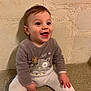 Nolan participe au concours pour gagner de l'argent avec cette photo : baby, child, smiling, happy, pajamas, owl, indoor, stone_wall, sitting, cute, cozy, young_child, face, person, infant, expression, joy, warm, clothing, floor