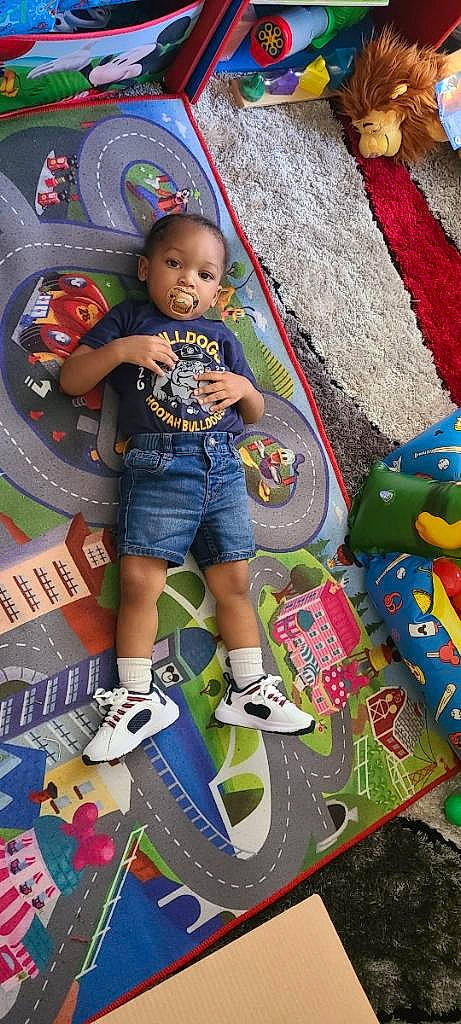 Legend is registered to the contest to win money with this photo: art, baby, baby_toddler_clothing, child, fun, games, leisure, pattern, person, play, product, recreation, sandal, shorts, snapshot, t_shirt, toddler, toy, visual_arts, wheel