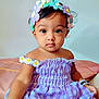 Luvella joined the competition — help win amazing prizes! child, toddler, dress, purple, gingham, flower_headband, bracelets, sitting, indoors, cute, portrait, face, big_eyes, skin, fashion, accessories, calm, baby, daisy, soft_background