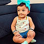 toddler, child, headband, bow, tank_top, strawberry_pattern, denim_shorts, socks, bracelets, cross_legged, couch, black_couch, indoor, cute, portrait, sitting, curious, young_child, person, baby