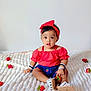 toddler, child, baby, red_headband, red_top, denim_shorts, white_sandals, strawberries, blanket, indoor, cute, sitting, looking, curious, infant, fashion, accessories, portrait, young_child, soft_texture