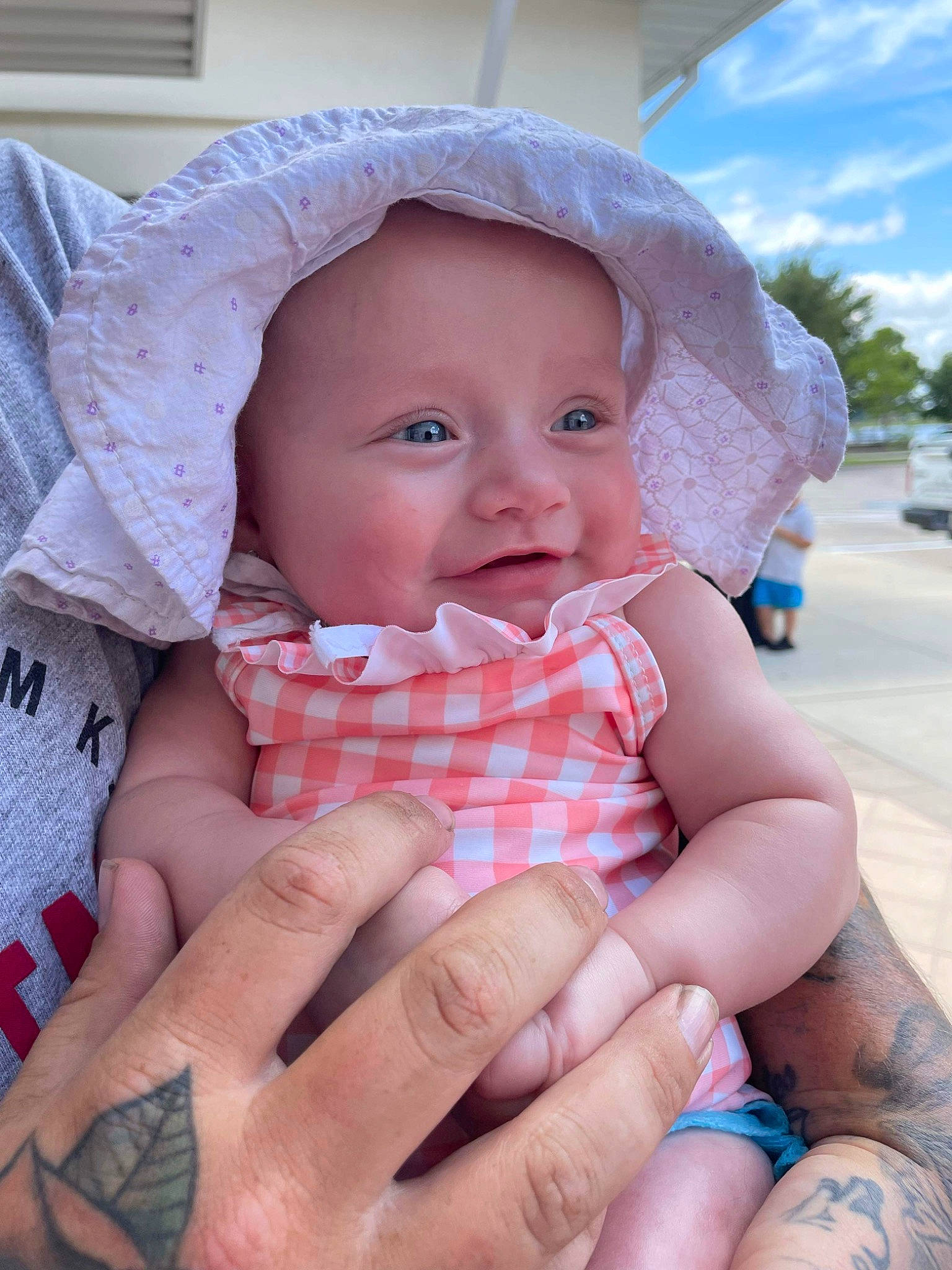 Annalise joined the competition — help win amazing prizes! baby, baby_toddler_clothing, blue, cheek, eye, finger, fun, gesture, hand, happy, headwear, lip, mouth, nail, nose, person, pink, skin, sky, smile