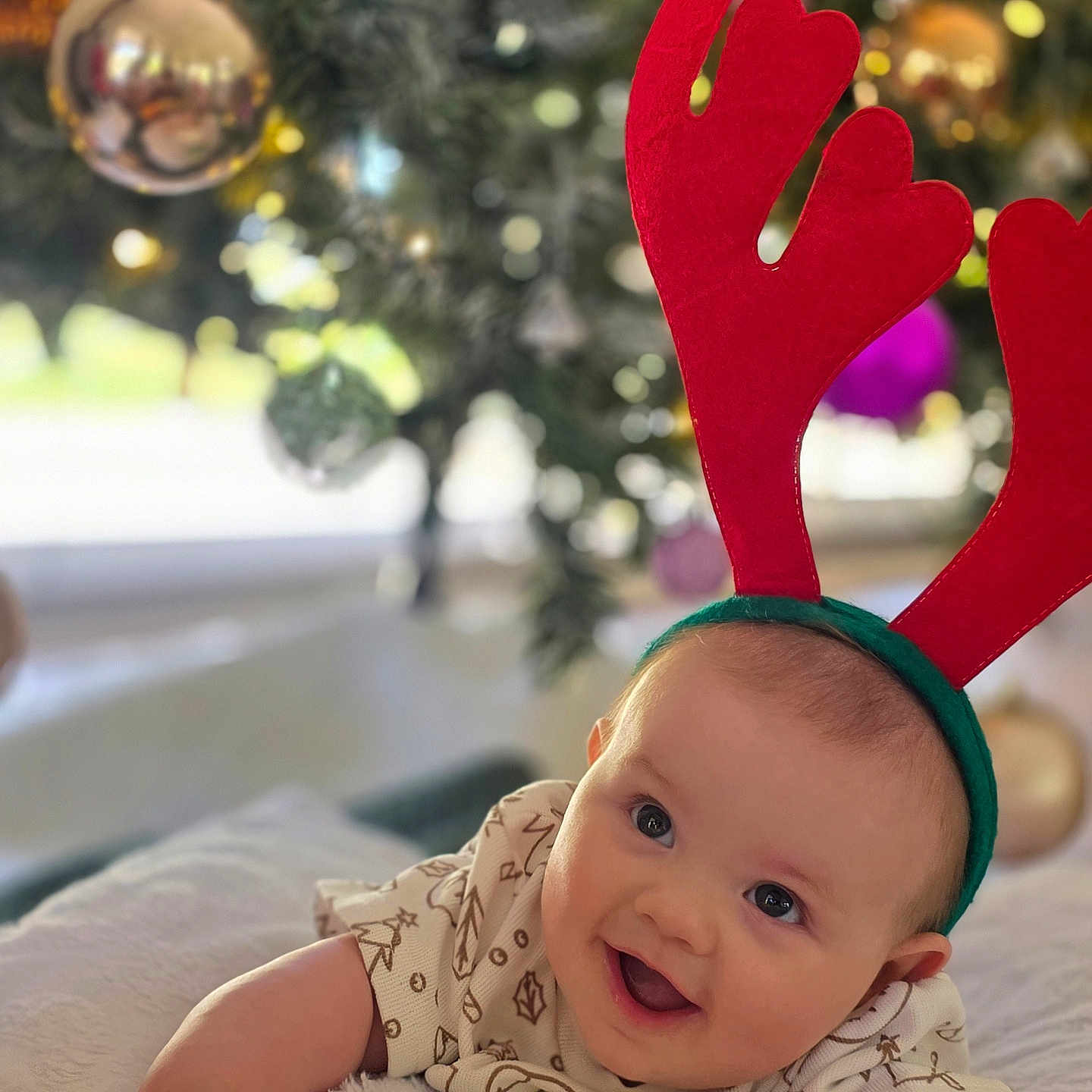 Rory joined the competition — help win amazing prizes! baby, blanket, celebration, child, christmas_tree, cute, decorations, festive, happy, holiday, holiday_clothing, holiday_season, holiday_spirit, indoors, infant, ornaments, portrait, red_antenna_headband, smile, soft