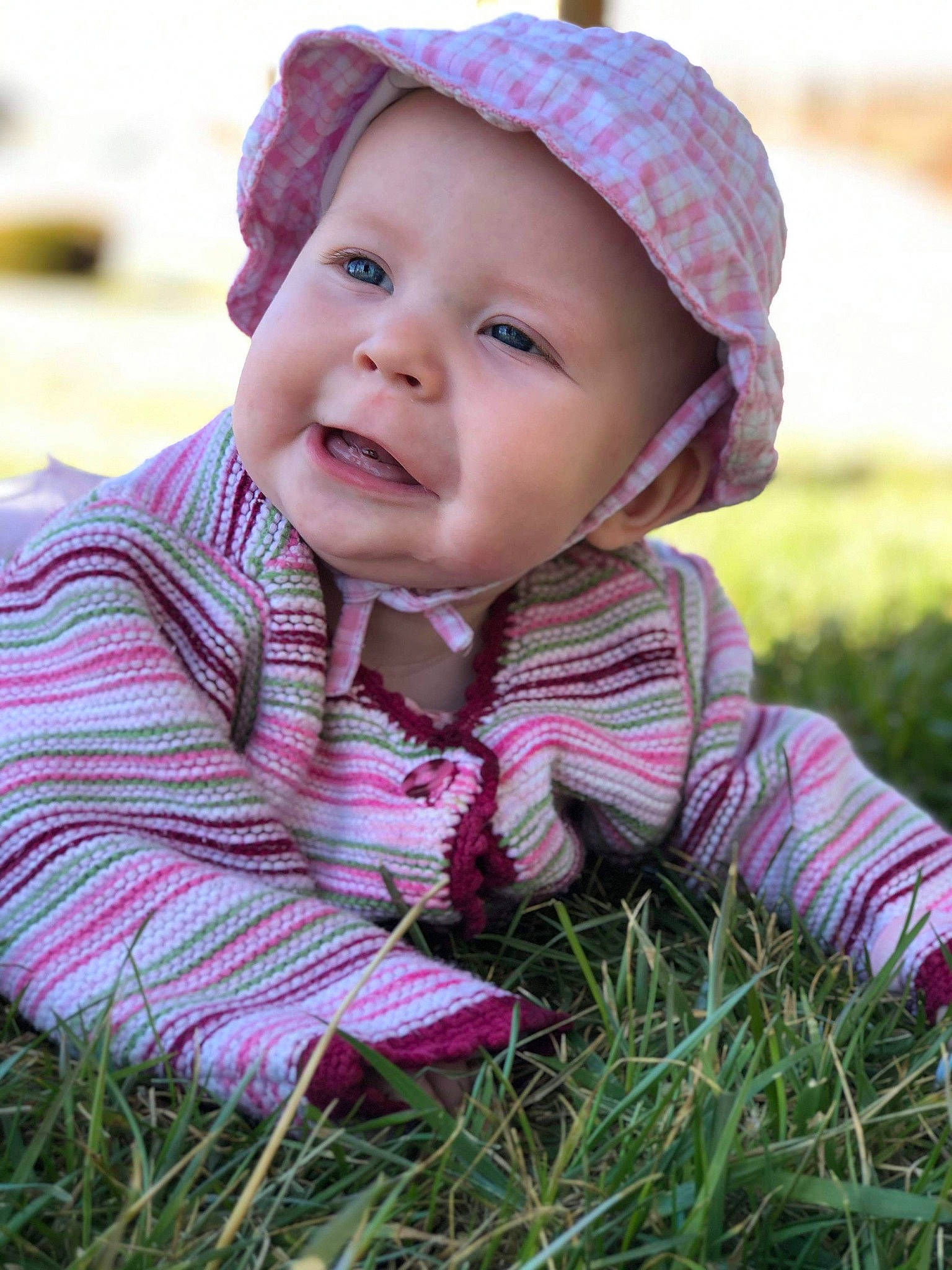 Pheonix is registered to the contest to win money with this photo: baby, beanie, bonnet, cap, cheek, child, child_model, face, grass, happy, hat, headgear, knit_cap, person, photography, pink, plant, portrait_photography, skin, smile