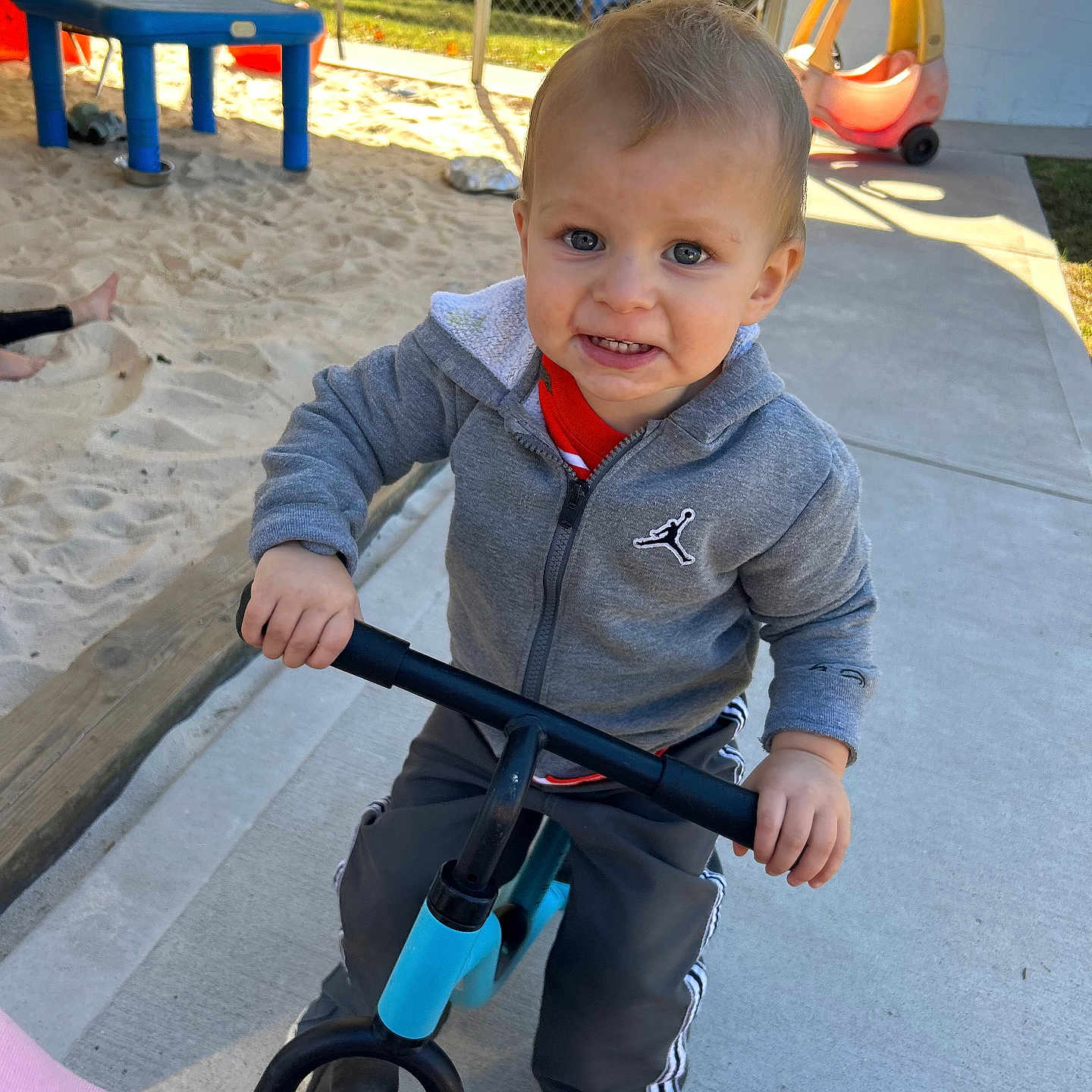 Tyler is registered to the contest to win money with this photo: baby, bicycle, boy, child, clothing, desk, face, furniture, head, male, outdoorplayarea, outdoors, pants, person, photography, playarea, portrait, table, transportation, vehicle